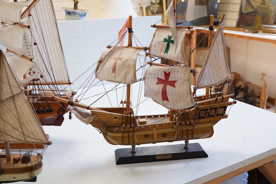 A collection of ten wooden models of famous ships including; the Cutty Sark, HMS Victory, the Mayflower, Revenge, and Santa Maria, largest 125cm wide